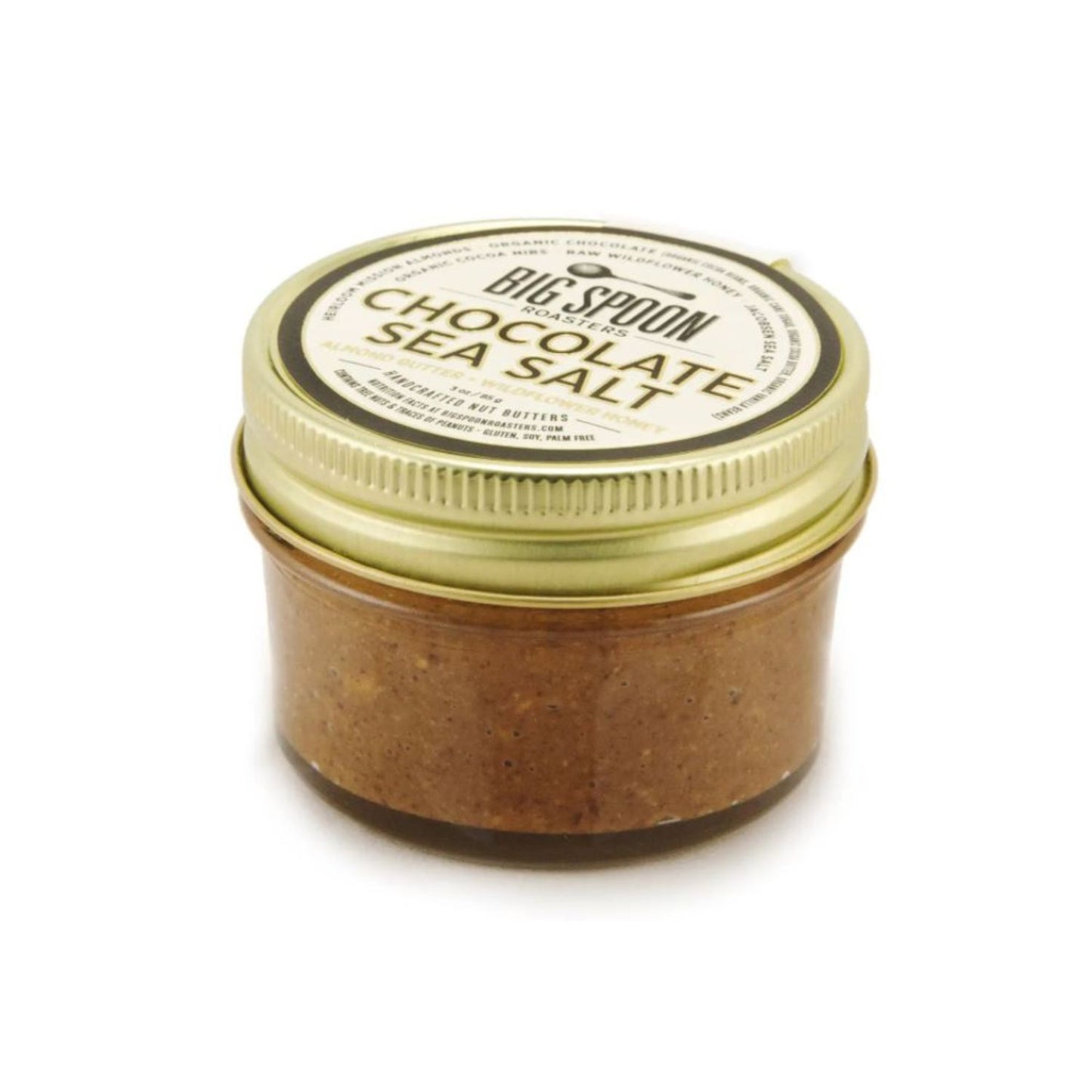 Jar of chocolate sea salt with a gold lid on a white background.