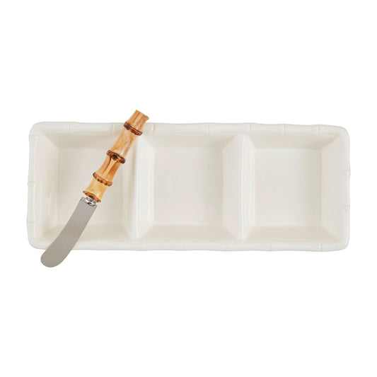 Rectangular white plate with a bamboo spreader on a white background.