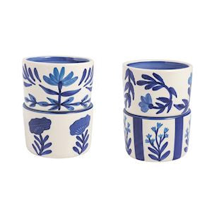 Set of three ceramic tumblers with blue floral patterns on a white background.