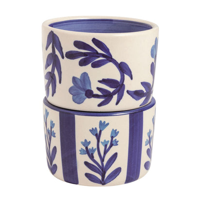 Stack of two ceramic pots with blue floral patterns on a white background.