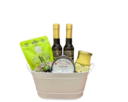 For that special someone who really likes to cook, this basket features a bottle of our Garlic olive oil and Sicilian Lemon White Balsamic vinegar, along with a jar of Edmond Fallot Green Peppercorn Dijon Mustard, Tom Douglas Chicken Rub, To Market To Market Ain't No Joke, It's Spinach Artichoke Mix and a self-closing pour spout. Comes in a white oval tin that can be reused over and over!