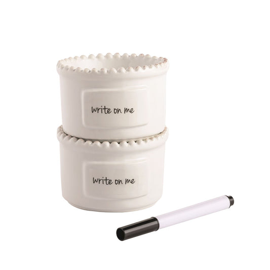 Two white ceramic containers with 'Write on me' text and a marker on a white background.