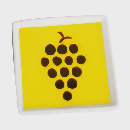 Square tile with a yellow background and brown grapevine design on a white background
