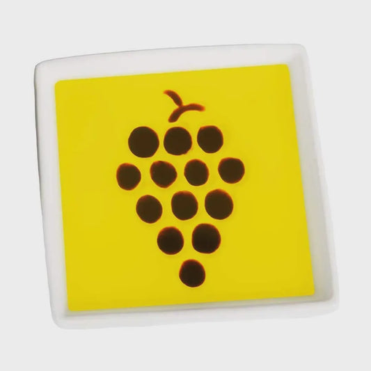 Square tile with a yellow background and brown grapevine design on a white background